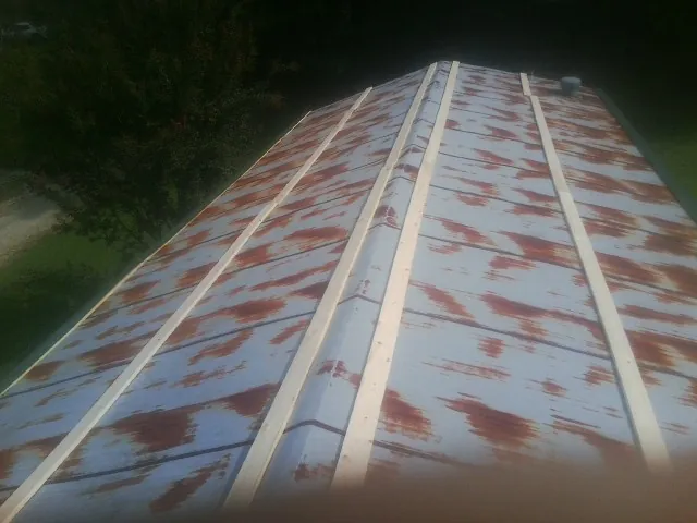 Rusted metal roof panels with new wood purlins before replacement — Storm Damage Roof Repair in Sarver by Roofing Brothers