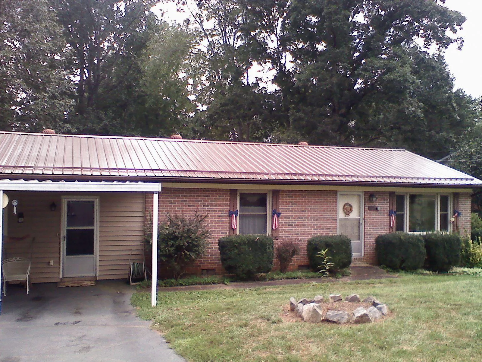 Bronze metal roof and carport on a brick ranch home — Roof Repair work by our crew in Sarver